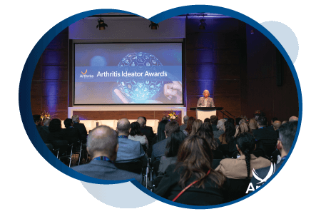 2022 Arthritis Ideator Awards<sup>TM</sup> event - people in a room, sitting and watching, listening to the speaker