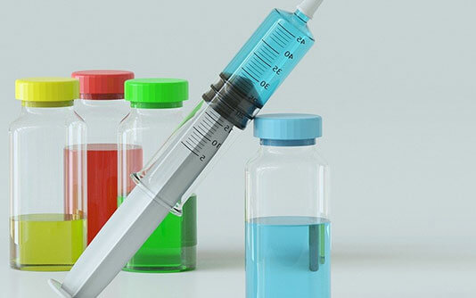 A syringe with colored tubes