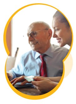 Older man with a younger woman looking at a laptop