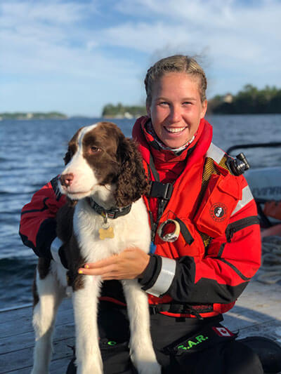 Claire Neilson in her Coast Guard uniform with her dog