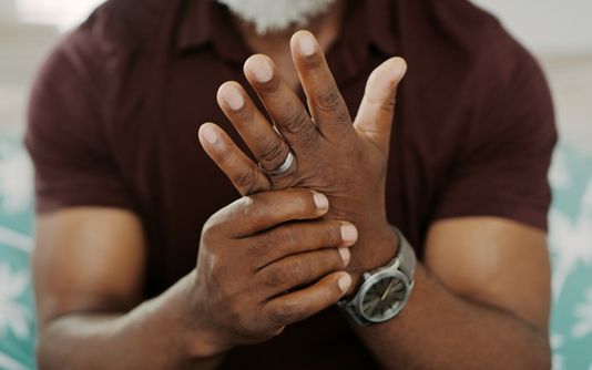 Man having pain in his hands and fingers