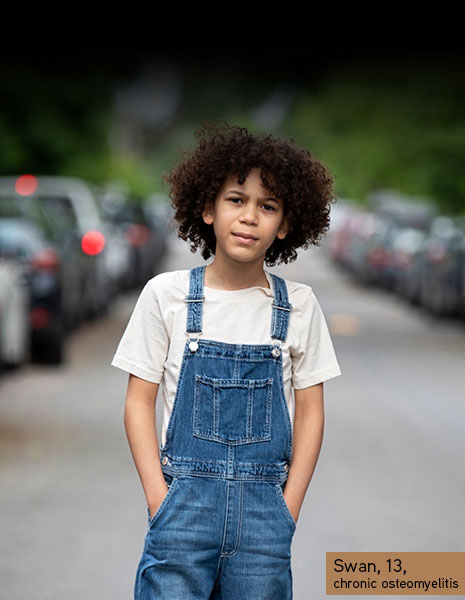 a kid with the street in background