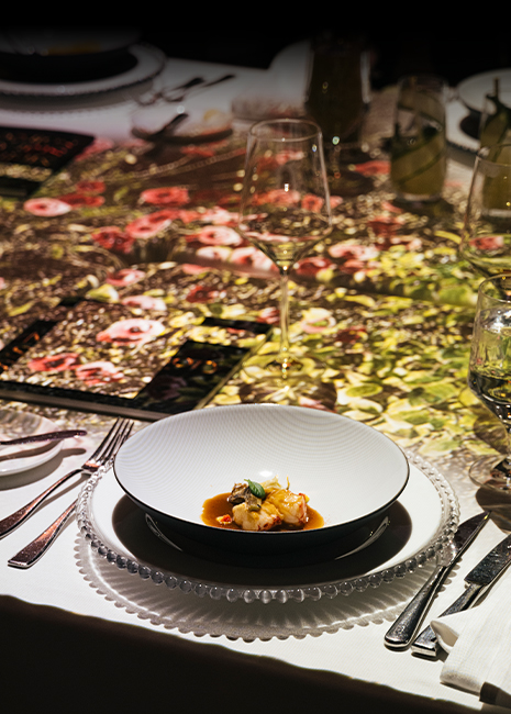 Guests seating at a table looking at an animated wall