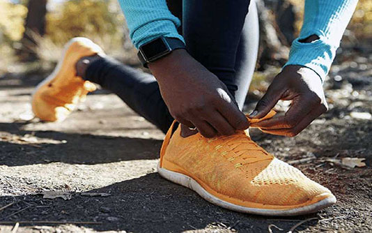 Man tying up running shoe laces