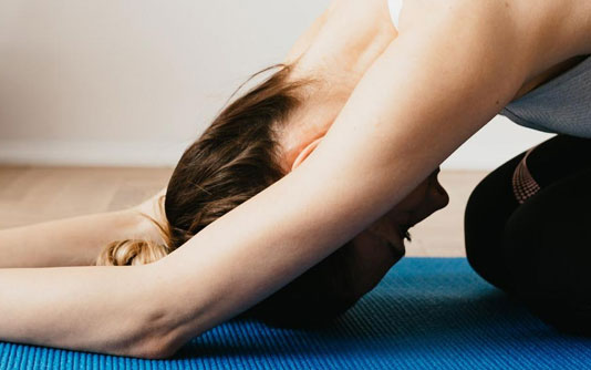 woman breathing on yoga mat